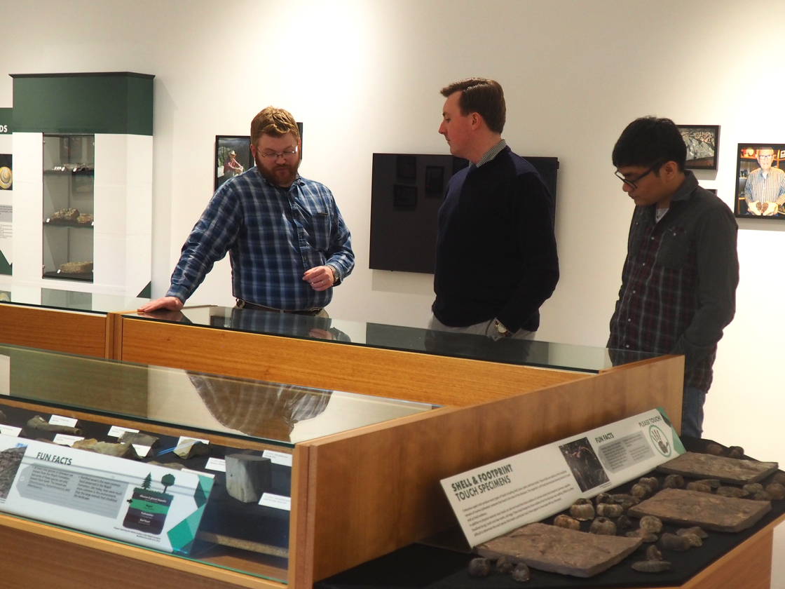 Derek Larson, the museum's assistant curator, explains fossils showcased in the newly opened Roy Bickell Fossil Collection exhibit