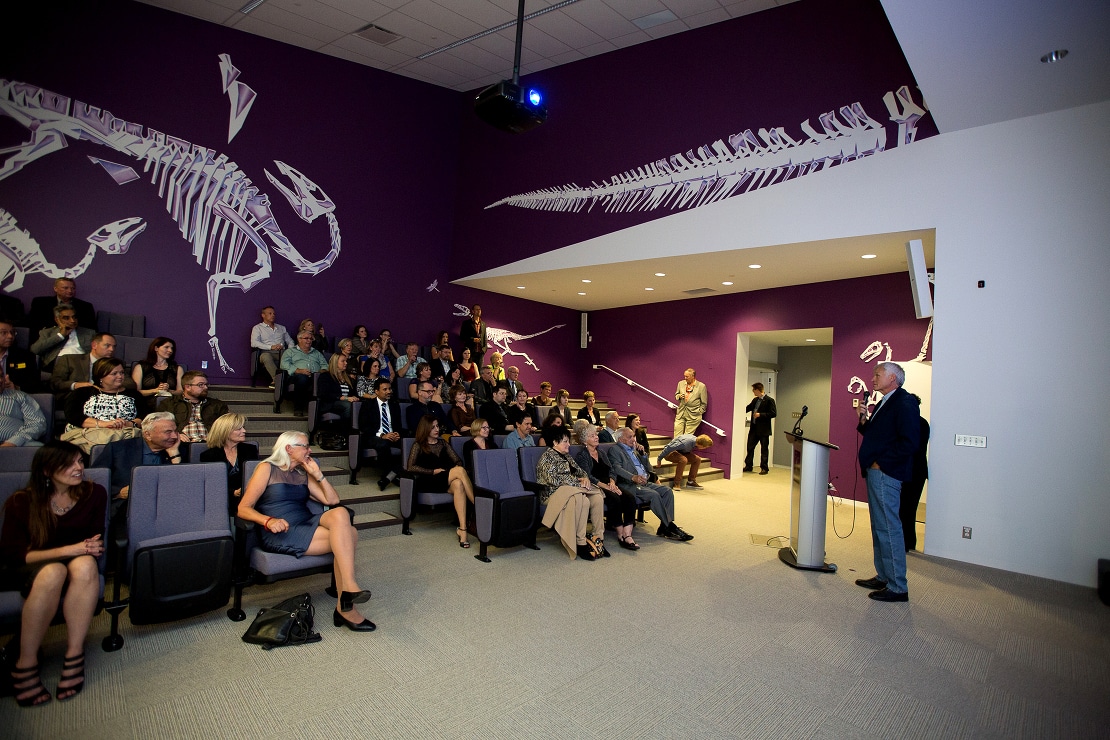 Dr. Currie addresses a crowd in the Aykroyd Family Theatre