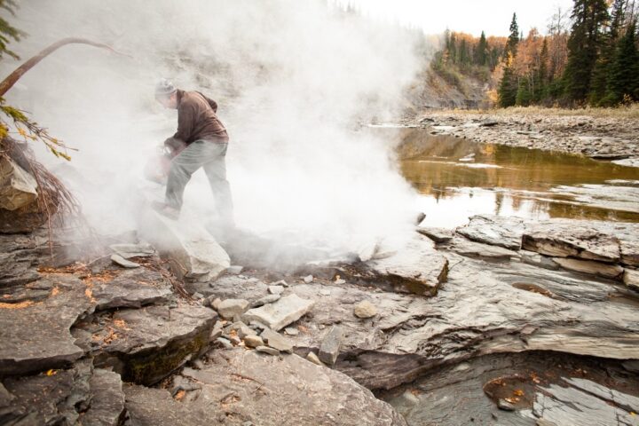 Clive Coy, dinosaur technician at the University of Alberta, wields a rock saw in what turned out to be a very brief attempt to cut down the size of the block. Photo: Chris Beauchamp.
